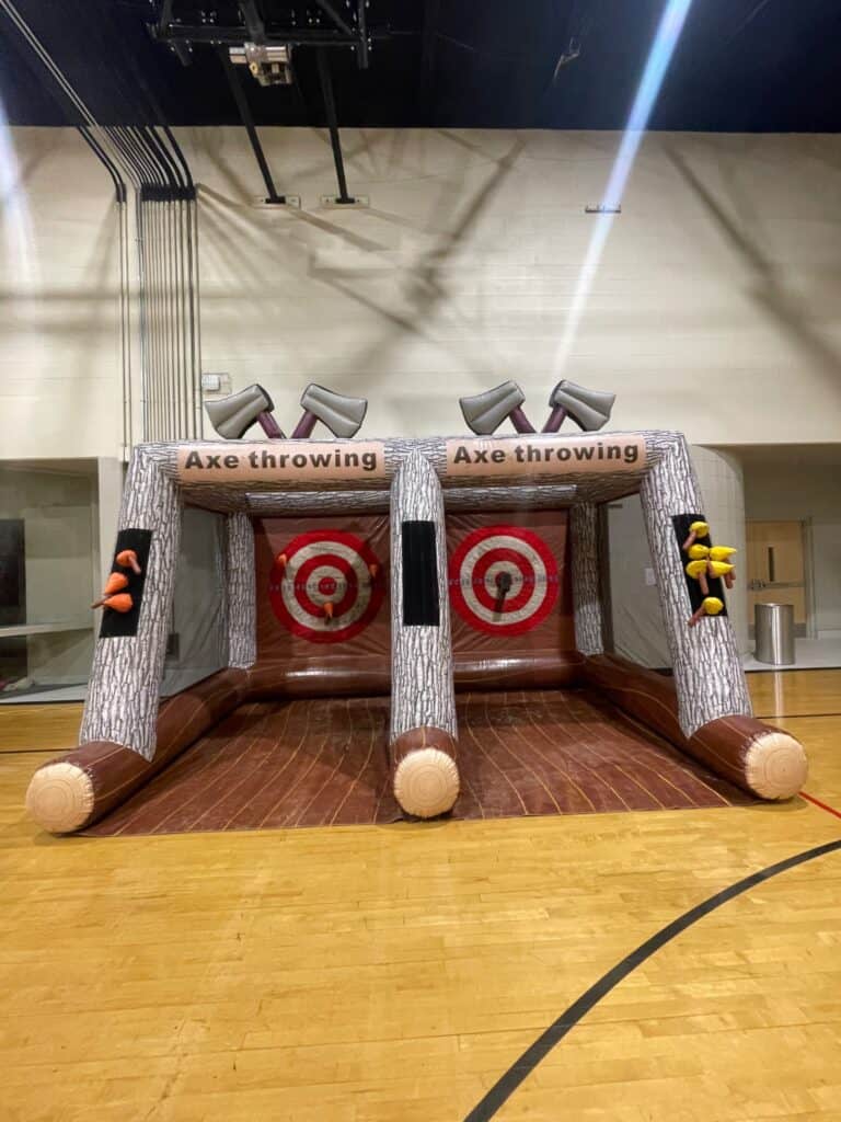Double axe throw inflatable game set up inside a church fellowship hall